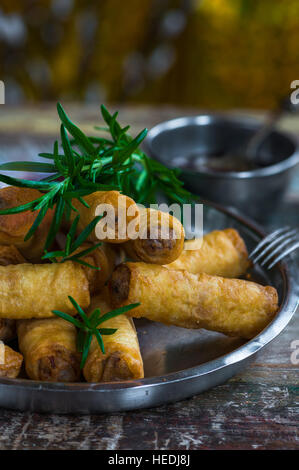 Fried Chinese duck spring rolls and sweet chili dip Stock Photo