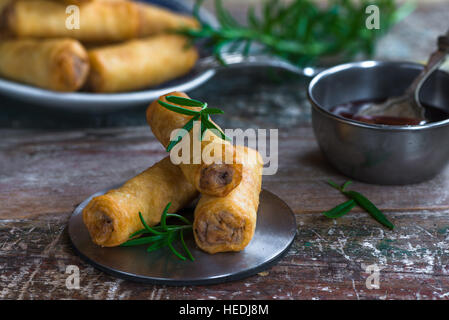 Fried Chinese duck spring rolls and sweet chili dip Stock Photo