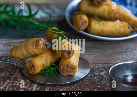 Fried Chinese duck spring rolls and sweet chili dip Stock Photo