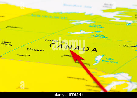 Red arrow pointing Canada on the map of north America continent Stock Photo