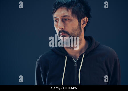 Confused man with so many questions looking to side for the answer to his problems Stock Photo