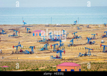 Oil pumps and rigs at the field by Caspian sea near Baku, Azerbaijan Stock Photo