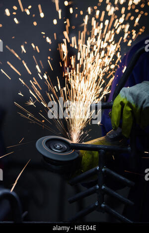 Metal sawing with sparks flying close up Stock Photo