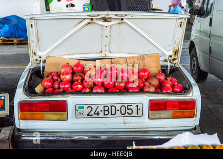 BAKU, AZERBAIJAN - SEPTEMBER 24: Ripe pomegranates for sale in old soviet Lada car in local market. September 2016 Stock Photo