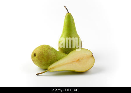 two whole fresh green pears and one half Stock Photo