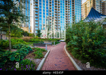 Walkway and modern buildings seen at Romare Bearden Park, in Uptown Charlotte, North Carolina. Stock Photo