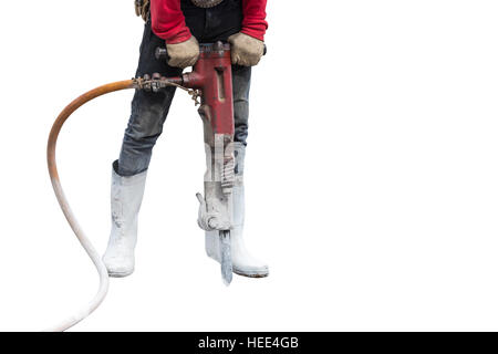 Construction worker removes excess concrete with drilling machine in construction site. Isolated on white background. Saved with clipping path Stock Photo