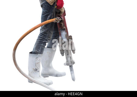 Construction worker removes excess concrete with drilling machine in construction site. Isolated on white background. Saved with clipping path Stock Photo