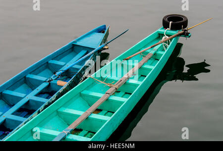 Two row boats floating side by side in water Stock Photo