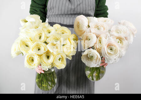 Beautiful bouquet of soft lemon and white ranunculus in woman's hands, mother day concept Stock Photo