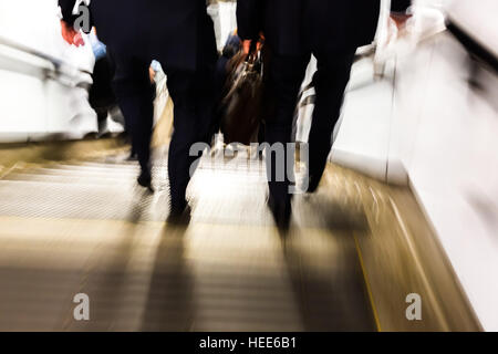 abstract blurred picture of commuters walking downstairs of an underground station Stock Photo