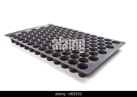 Black empty plastic tray with hole for seedlings isolated on white background Stock Photo