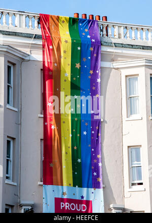 A rainbow flag hanging on building in Brighton, East Sussex, England, UK Stock Photo