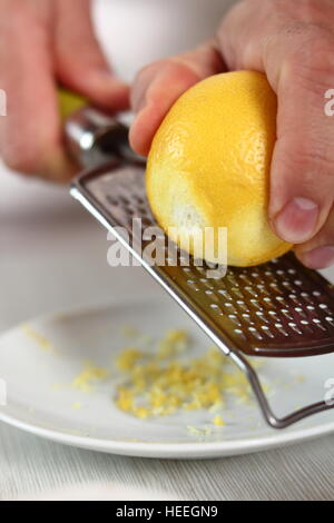 Grating lemon rind. Making Filo Pastry Topped Apple Pie Series. Stock Photo