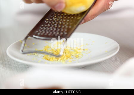 Grating lemon rind. Making Filo Pastry Topped Apple Pie Series. Stock Photo