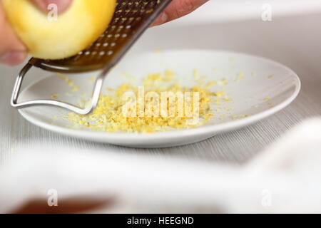 Grating lemon rind. Making Filo Pastry Topped Apple Pie Series. Stock Photo