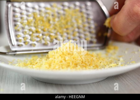 Grating lemon rind. Making Filo Pastry Topped Apple Pie Series. Stock Photo