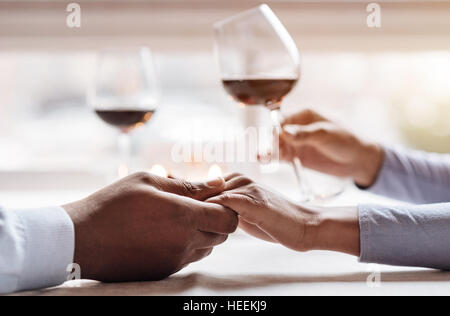 Positive African American couple enjoying the beverage in the restaurant Stock Photo