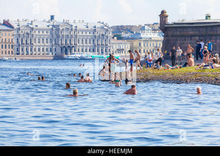 SAINT PETERSBURG, RUSSIA - JULY 26, 2014:  Residents swim in the river Neva on the beach near the Peter and Paul fortress in the hot summer Stock Photo