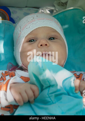 The little girl in the stroller in the fresh air Stock Photo