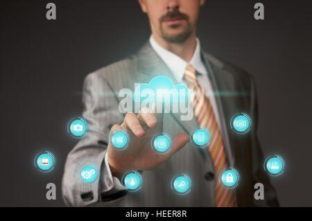 Businessman pushing cloud button on touch screen Stock Photo