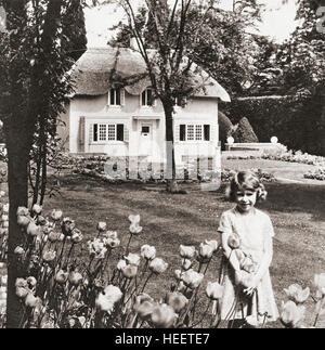 Princess Elizabeth at Y Bwthyn Bach or The Little House, situated in the garden of the Royal Lodge, Windsor Great Park, Berkshire, England. This miniature cottage was a gift to her from the people of Wales.  Princess Elizabeth, future Queen Elizabeth II, seen here aged nine.  Elizabeth II, 1926 - 2022. Queen of the United Kingdom, Canada, Australia and New Zealand. Stock Photo