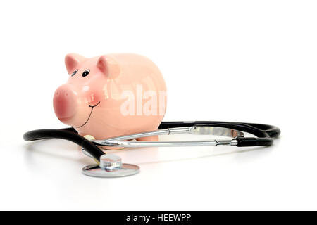 Piggy bank and Stethoscope Isolated on white background suggesting savings for medical cost Stock Photo