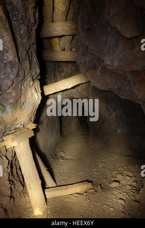 Inside an abandoned gold mine in the Nevada desert showing timbers and support structure. Stock Photo