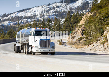 Tanker Big Rig Semi Truck on Snowy Mountain Pass Stock Photo