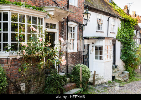 17th century houses, with small flight of three steps to front doors, one house brick, other white rendered, along narrow cobbled Mermaid Street. Stock Photo
