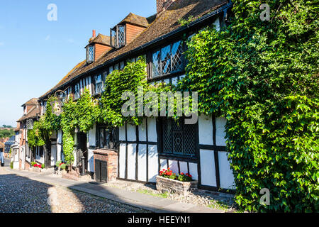 Historic English town of Rye. Cobbled lane and 15th century (1420), timber framed Tudor style building, 'The Mermaid Inn'. Sunshine, daytime. Stock Photo
