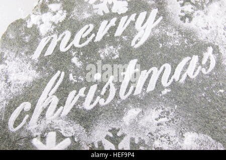 Merry Christmas note written with sugar powder and holiday cookies Stock Photo