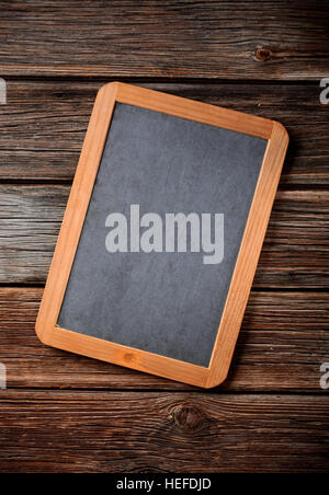 empty blackboard in the foreground on the wooden table Stock Photo