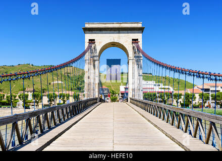 The Marc Seguin Bridge looking towards the town and vineyards of Tain-l'Hermitage, Drôme, Auvergne-Rhône-Alpes, France Stock Photo