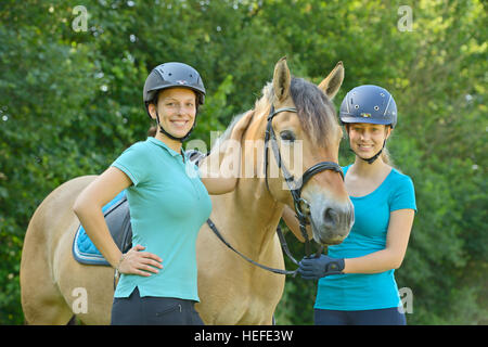 Two girls with a Norwegian Fjord horse Stock Photo