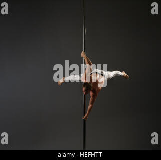 Pole dancer making exercises studio shot Stock Photo