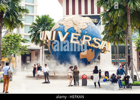 Tourists and theme park visitors taking pictures of the large rotating globe fountain in front  Universal Studios Stock Photo