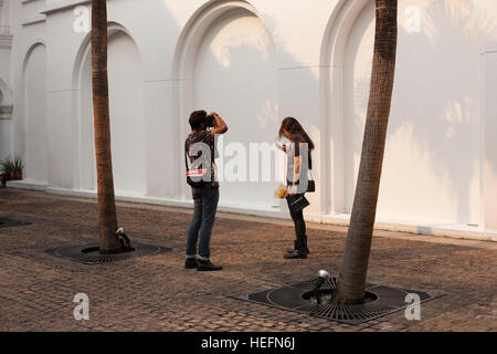 Boy and girl photographed on a background of  wall Stock Photo