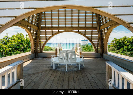 Beachside pavilion in Seaside Florida with white sand beach and clear blue Gulf of Mexico water in the background. Stock Photo