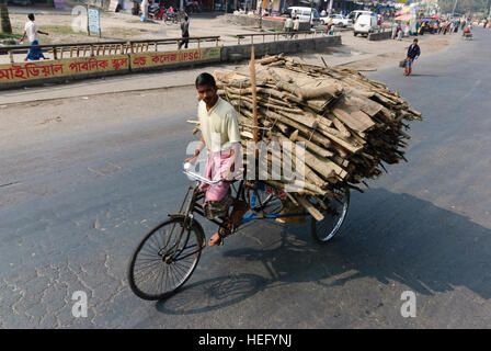Jessore: Street scene, bicycle rickshaw with firewood, Khulna Division, Bangladesh Stock Photo