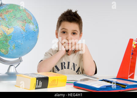 Schoolboy, seven-year-old boy doing his homework