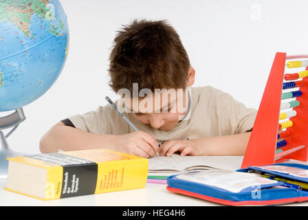Schoolboy, seven-year-old boy doing his homework