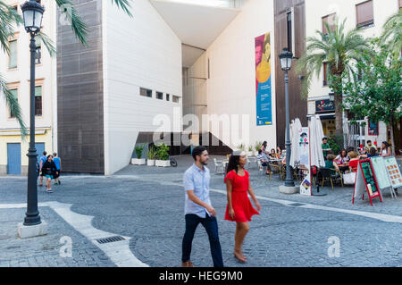 Young couple walks past the Centro Federico García Lorca in Plaza de la Romanilla Granada, Andalusia, Spain Stock Photo