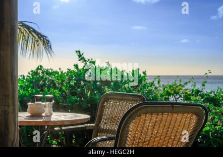 Curacao, Caribbean - october 1, 2012: Romantic restaurant at the Sandy Beach covered with million fragments of shells on a Caribbean Island. Blue sky  Stock Photo