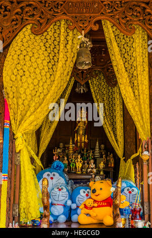 funny altar with toy offerings at Bangkok Thailand Stock Photo