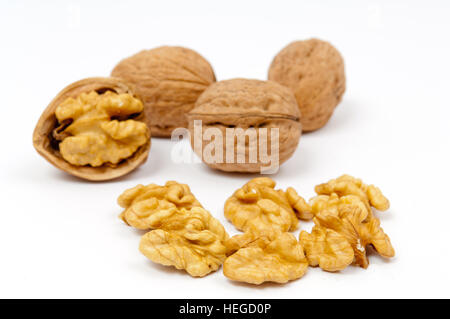 Whole walnuts and walnut kernels on white background Stock Photo