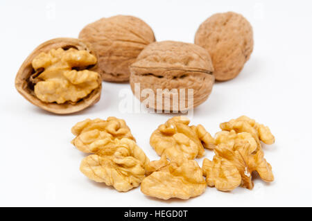 Whole walnuts and walnut kernels on white background Stock Photo