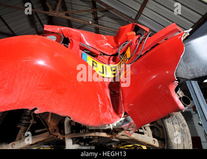 Car wreck. Crash damaged Mk1 Mazda MX5 with the rear bumper folded double after hitting a post backwards (no one was injured) Stock Photo