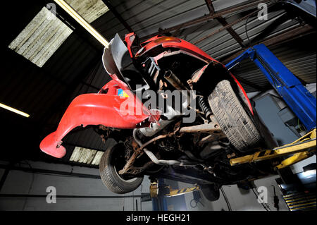 Car wreck. Crash damaged Mk1 Mazda MX5 with the rear bumper folded double after hitting a post backwards (no one was injured) Stock Photo