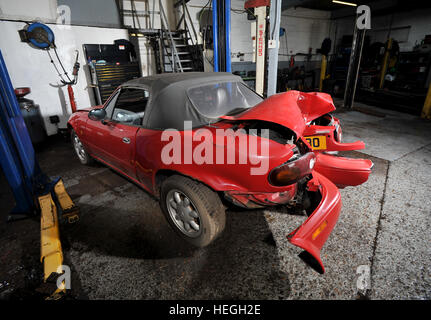 Car wreck. Crash damaged Mk1 Mazda MX5 with the rear bumper folded double after hitting a post backwards (no one was injured) Stock Photo